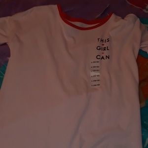 A pink shit with wording on it